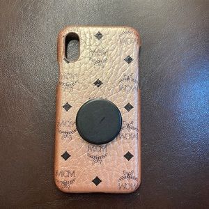 MCM IPHONE X - Color: Rose Gold.  Case has an attached Black Pop Socket.